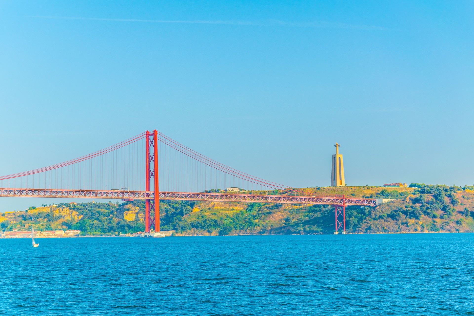puente 25 de abril bridge with The Cristo Rei monument of Jesus Christ in Lisbon, Portugal.